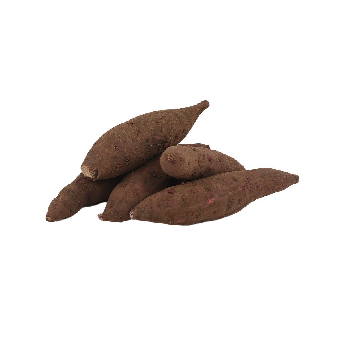 Organic purple sweet potatoes, unpeeled, in a small pile