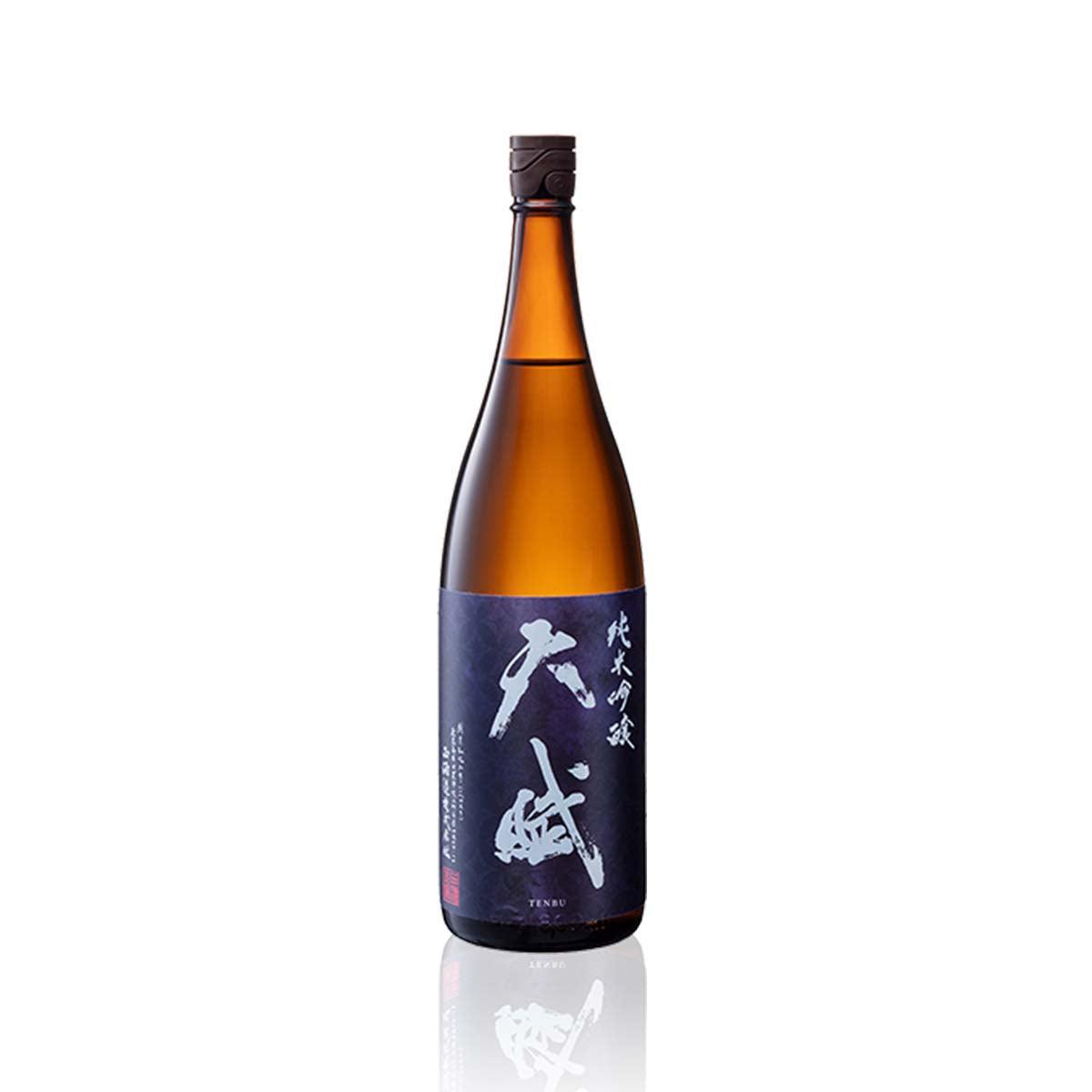 NISHI Tenbu Junmai Ginjo sake bottle with amber glass and dark blue label