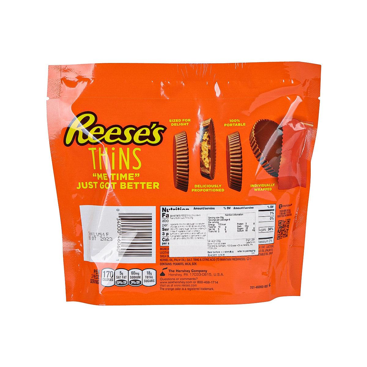 Reese's Thins bag back, nutrition label and ingredient text on orange packaging.