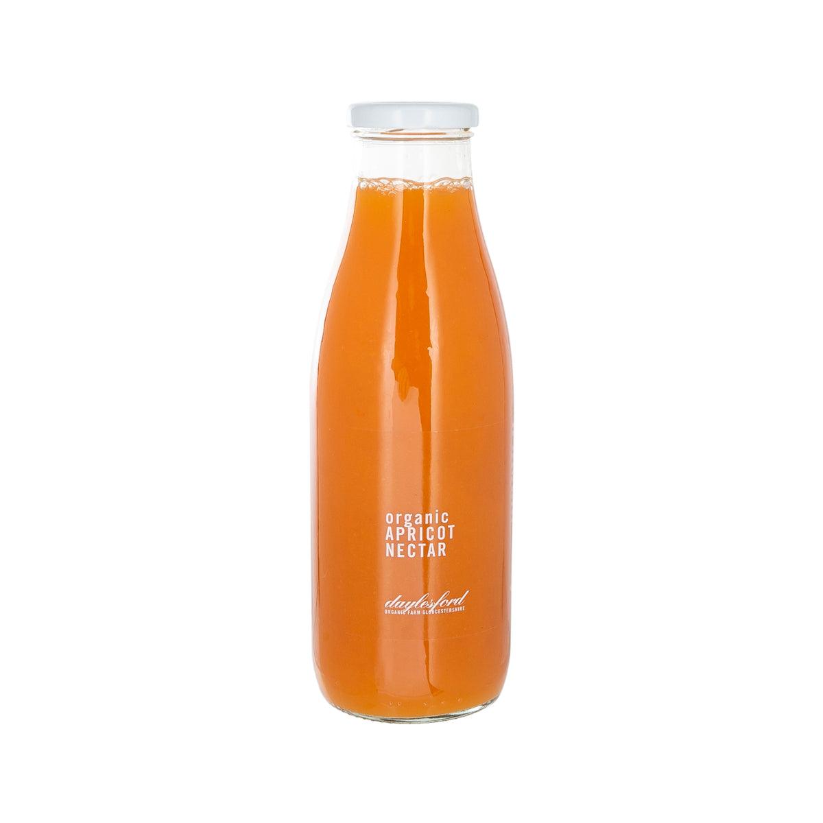 DAYLESFORD organic apricot nectar in clear glass bottle with white cap, orange liquid