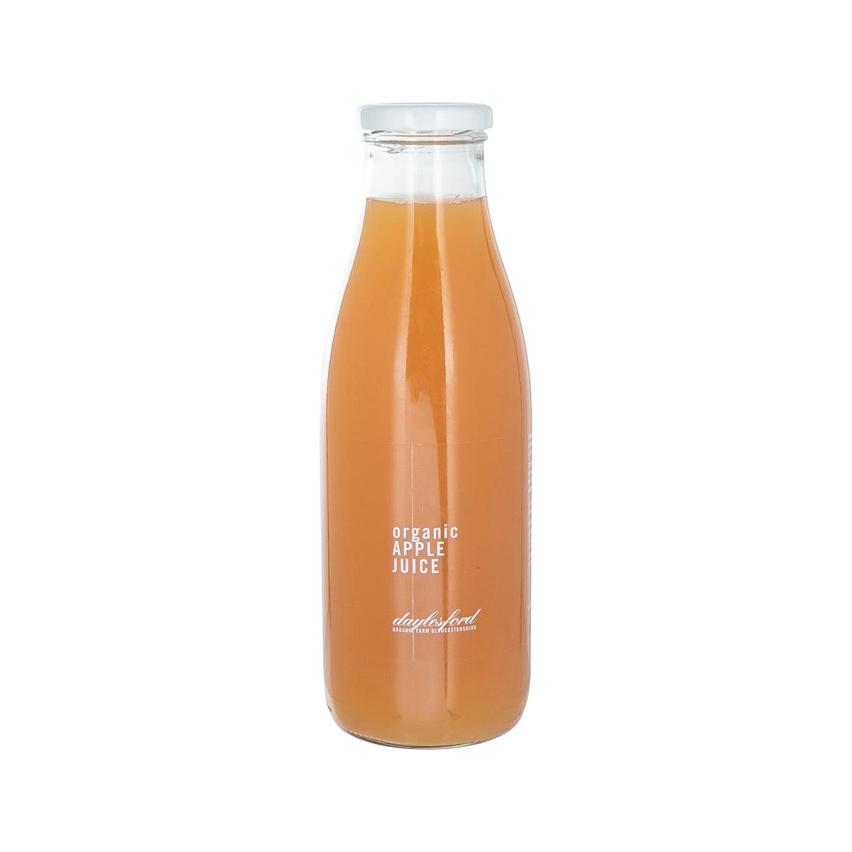 DAYLESFORD organic apple juice bottle, clear glass with orange juice and front label