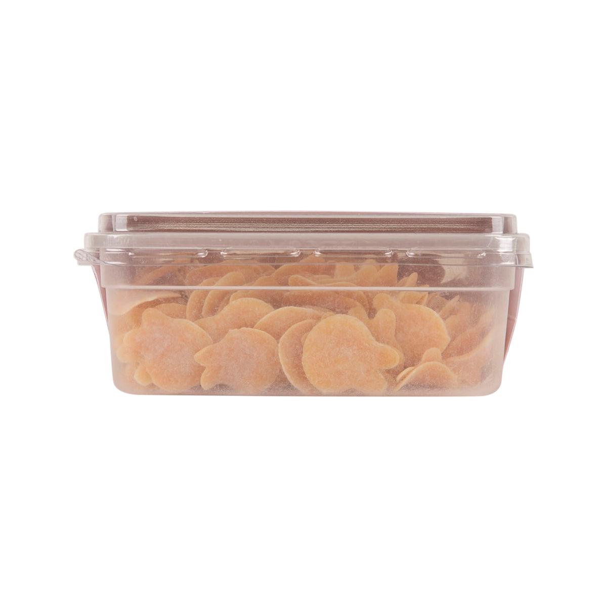 Plastic container filled with carrot-colored star-shaped noodles