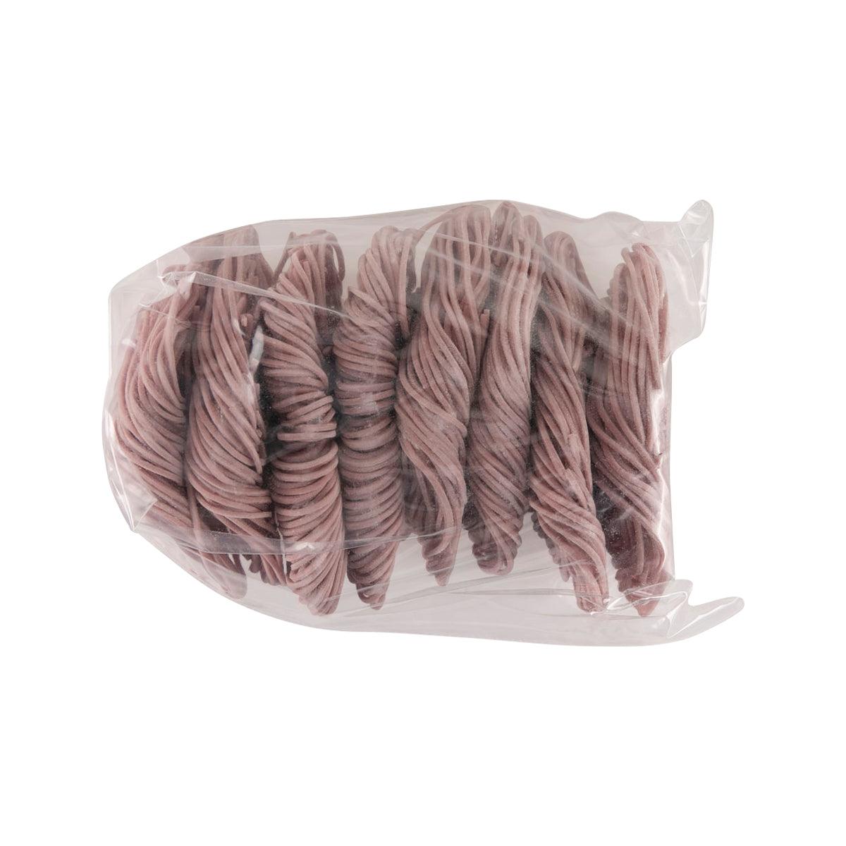 Pack of purple sweet potato noodles in clear plastic bag, coiled strands