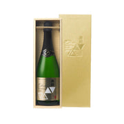 Sparkling sake bottle in open wooden gift box, dark green glass and foil label