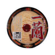 Instant tonkotsu noodle cup with lid showing ramen noodles and red paste, barcode label