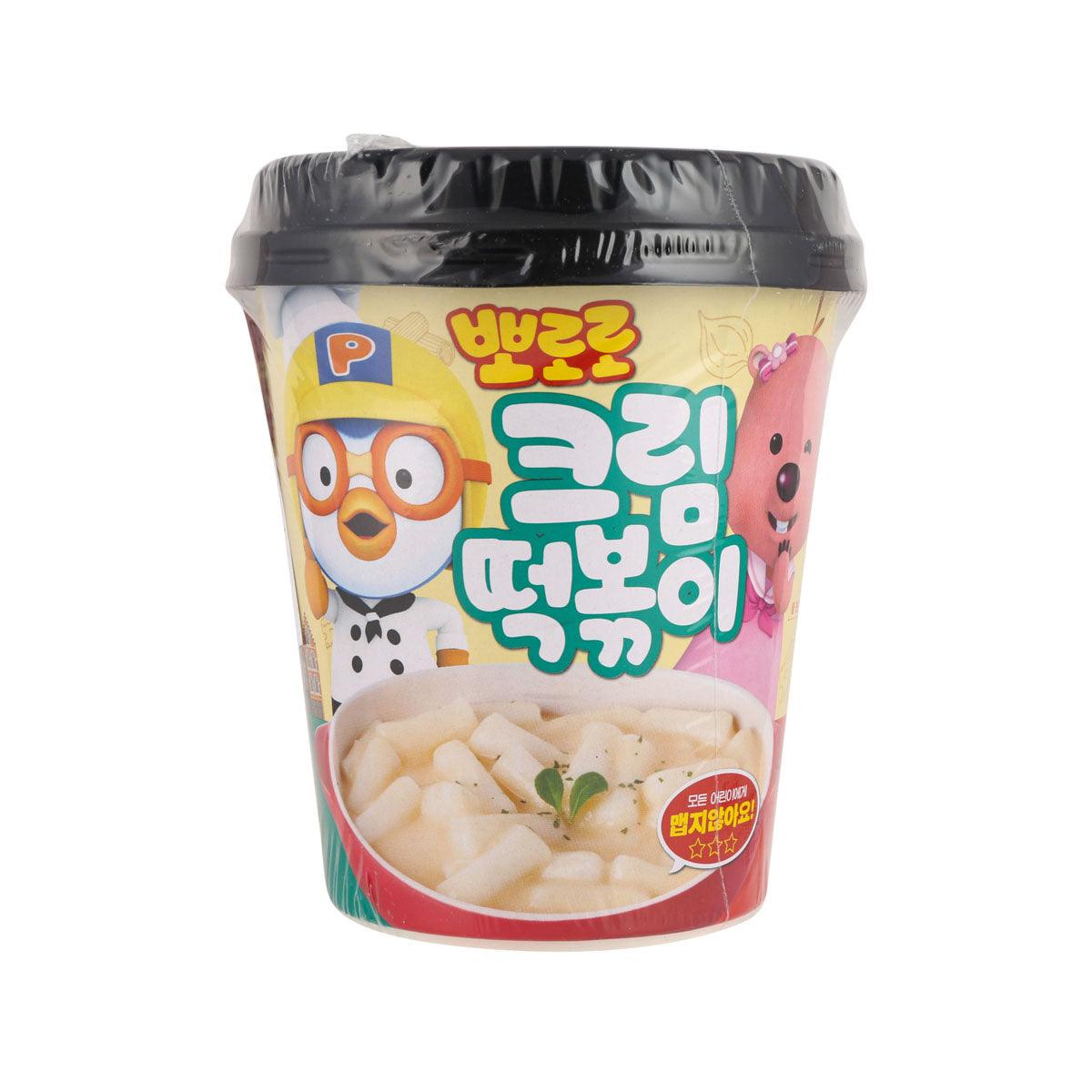 Cream tteokbokki instant cup with black lid, front graphic and rice cake bowl