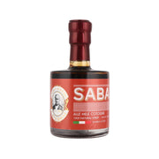 Saba balsamic dressing bottle with SABA label, dark glass and red cap, 100 mL