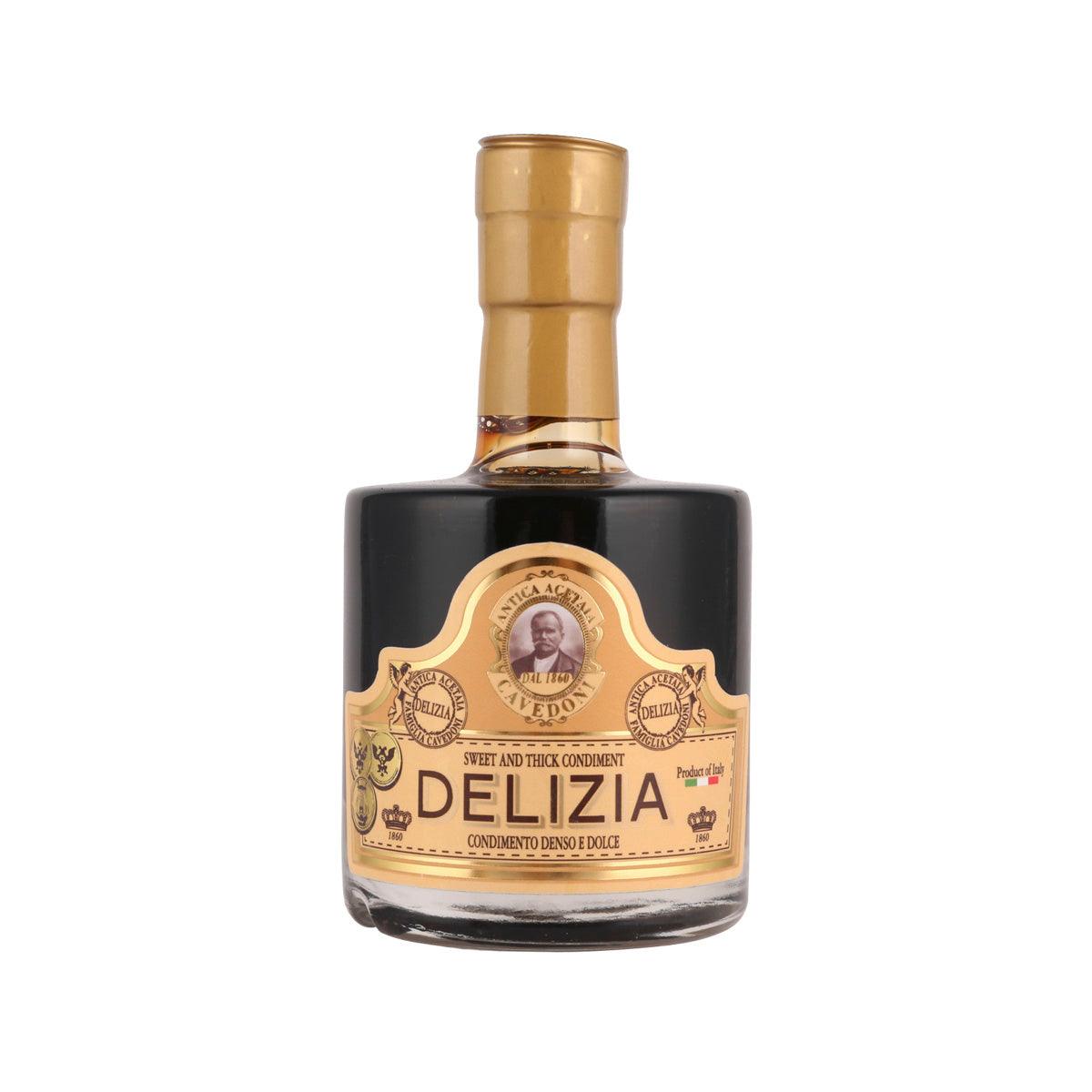 Sweet and thick balsamic vinegar bottle with cork top, dark glass and gold label