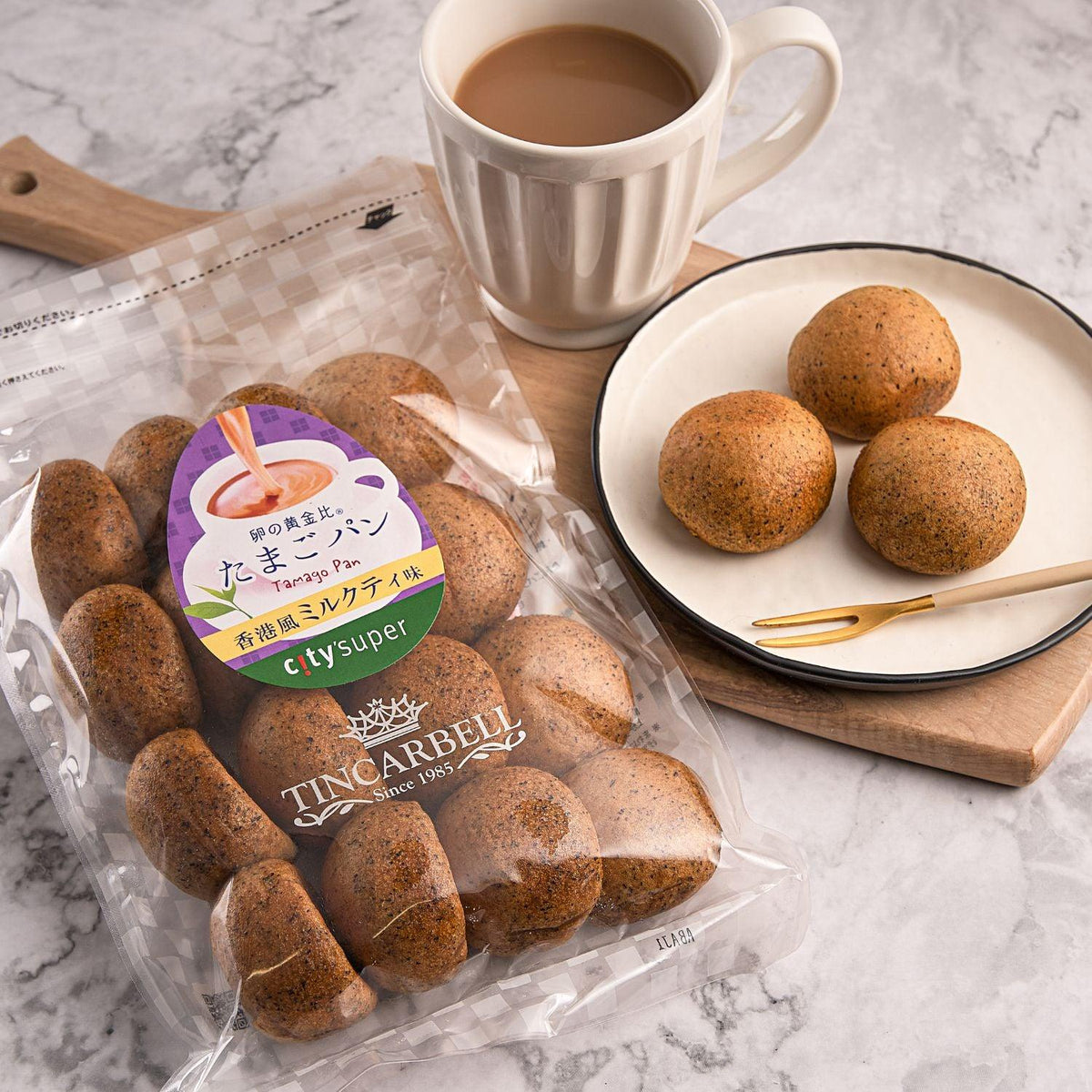 Tincarbell egg bread bag with dark brown rolls; three pieces on plate