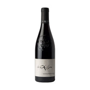 Wine bottle with dark glass, black cap, and white label