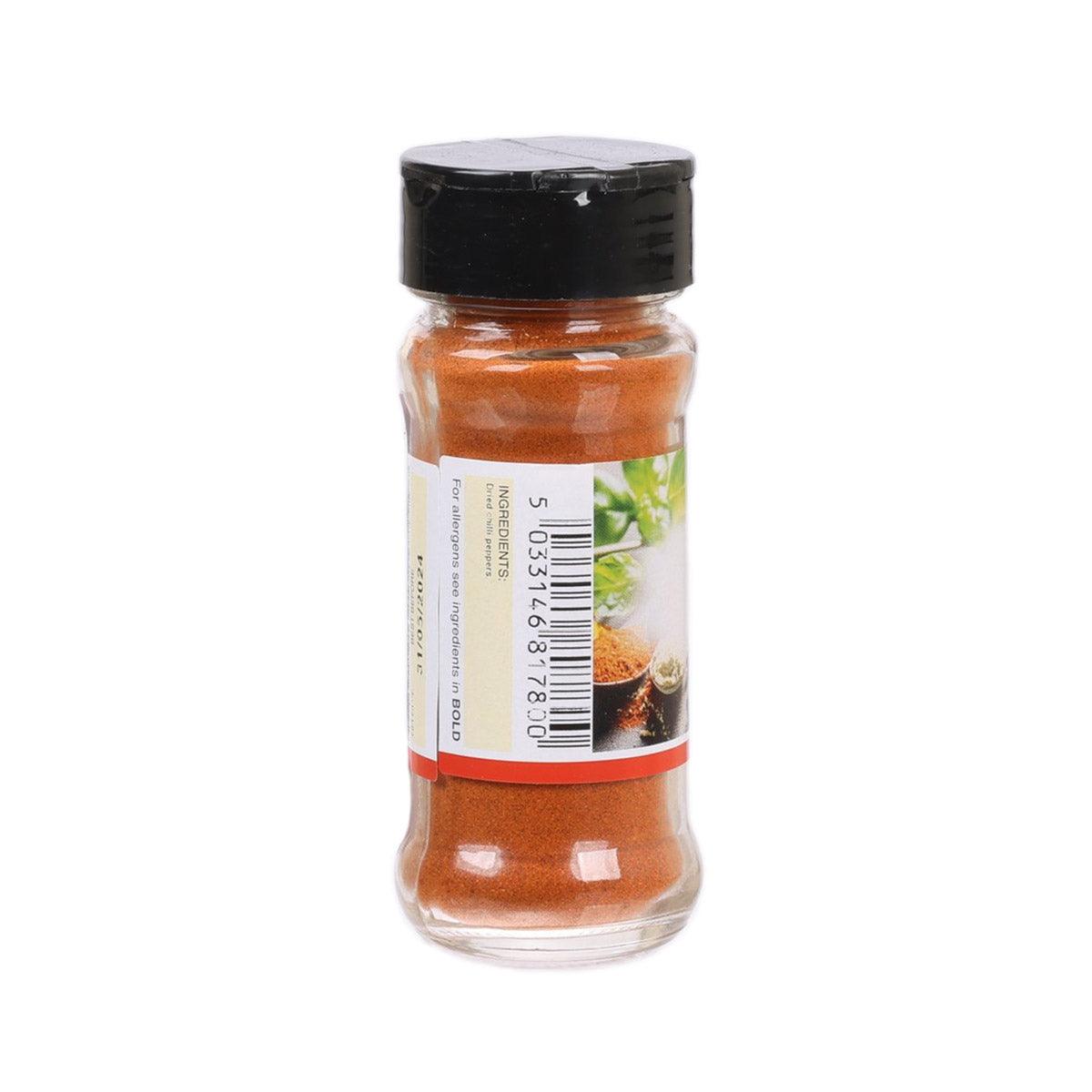 Green Cuisine chili powder bottle, barcode label side, black cap, orange spice
