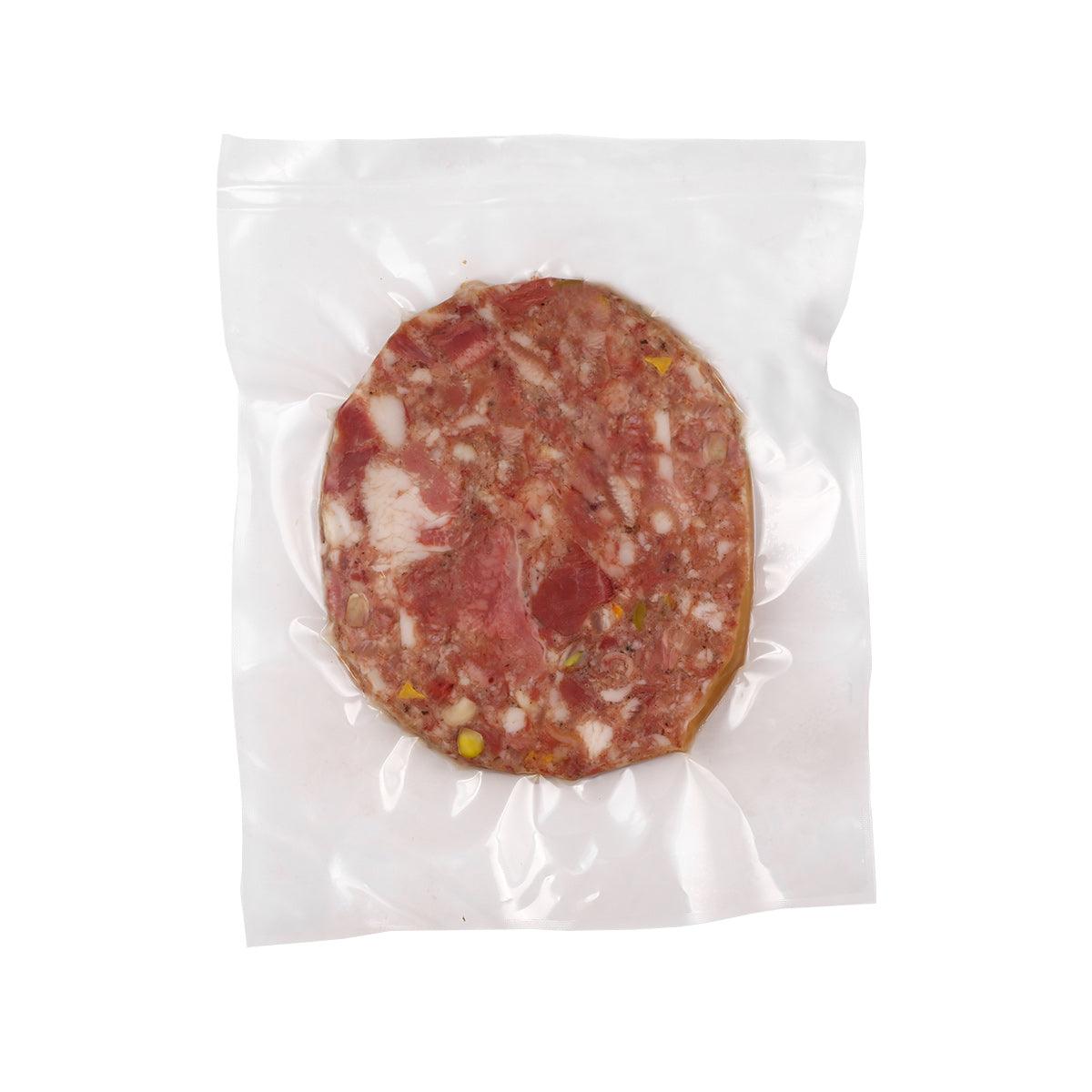 Pig head sausage slice in vacuum-sealed bag, red cured meat with visible fat pieces