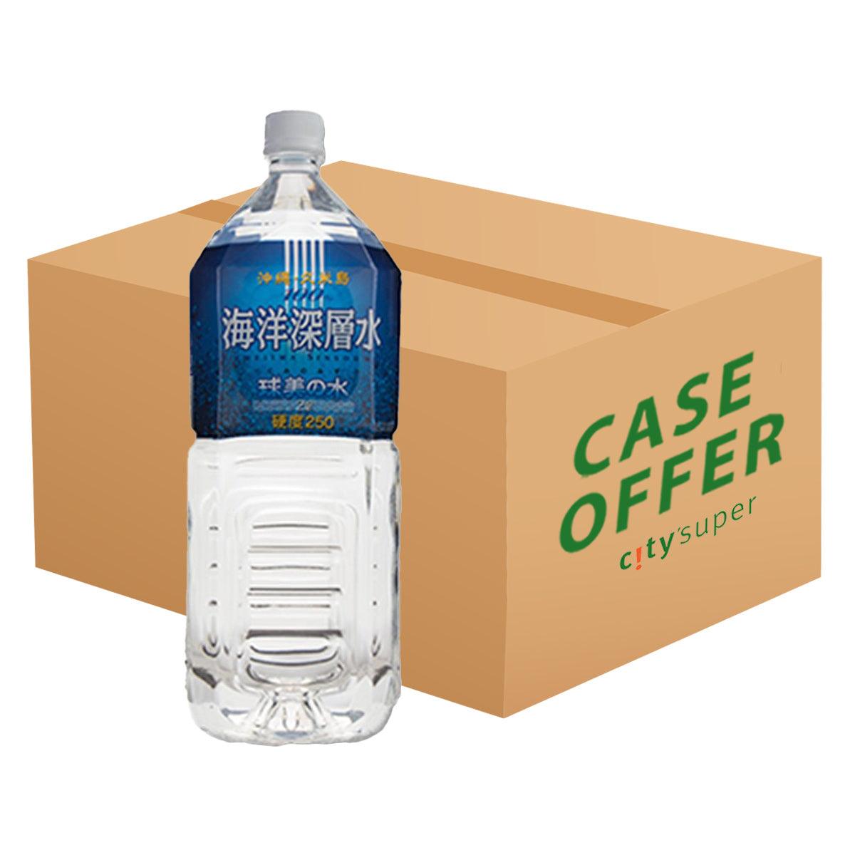 2L bottled water bottle with blue label standing in a carton for 6-pack