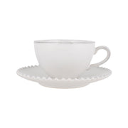 White tea cup with matching saucer, handle and scalloped rim