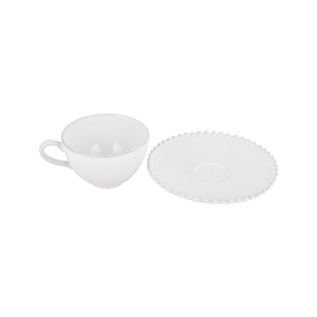 White teacup and matching saucer, cup beside saucer
