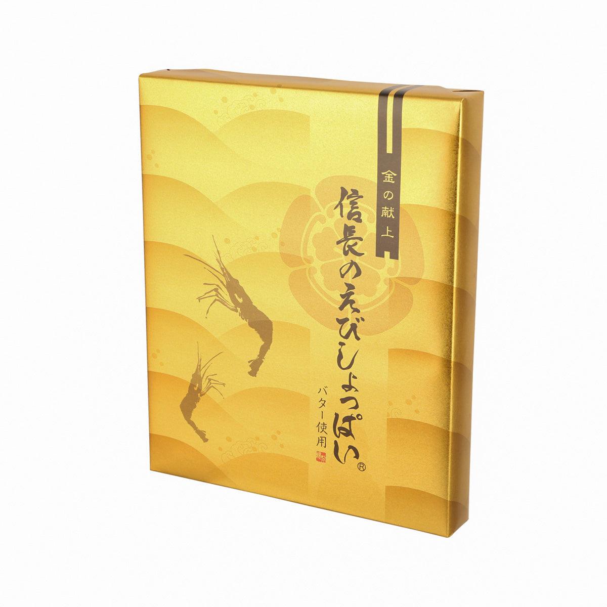 Shrimp cracker gift box angled view, gold wrap with shrimp design and Japanese text