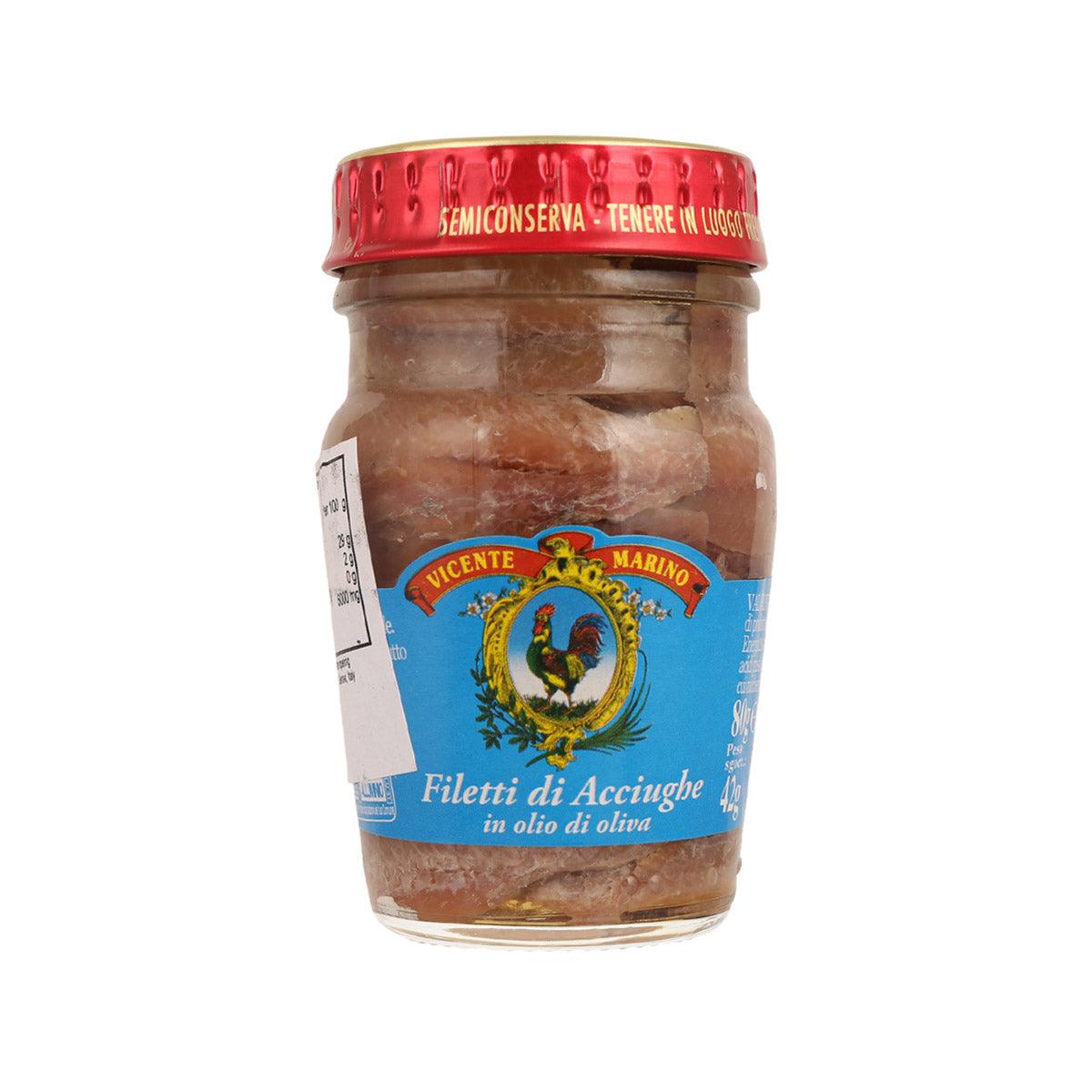 Small jar of Mediterranean anchovy fillets in olive oil, glass container with red lid