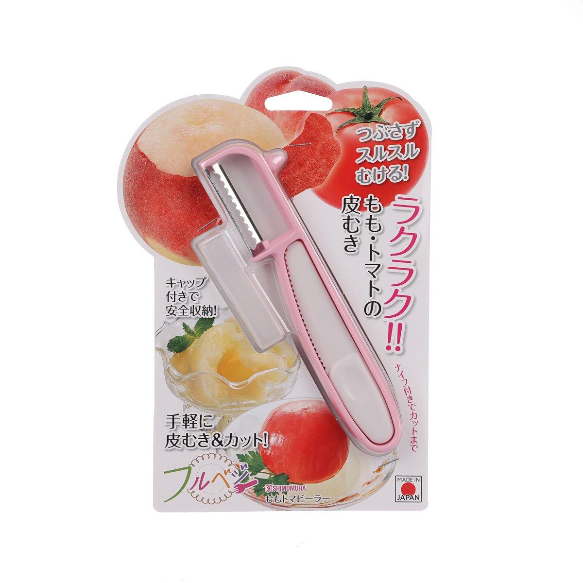 Pink and silver fruit peeler in retail packaging with peach and tomato graphic