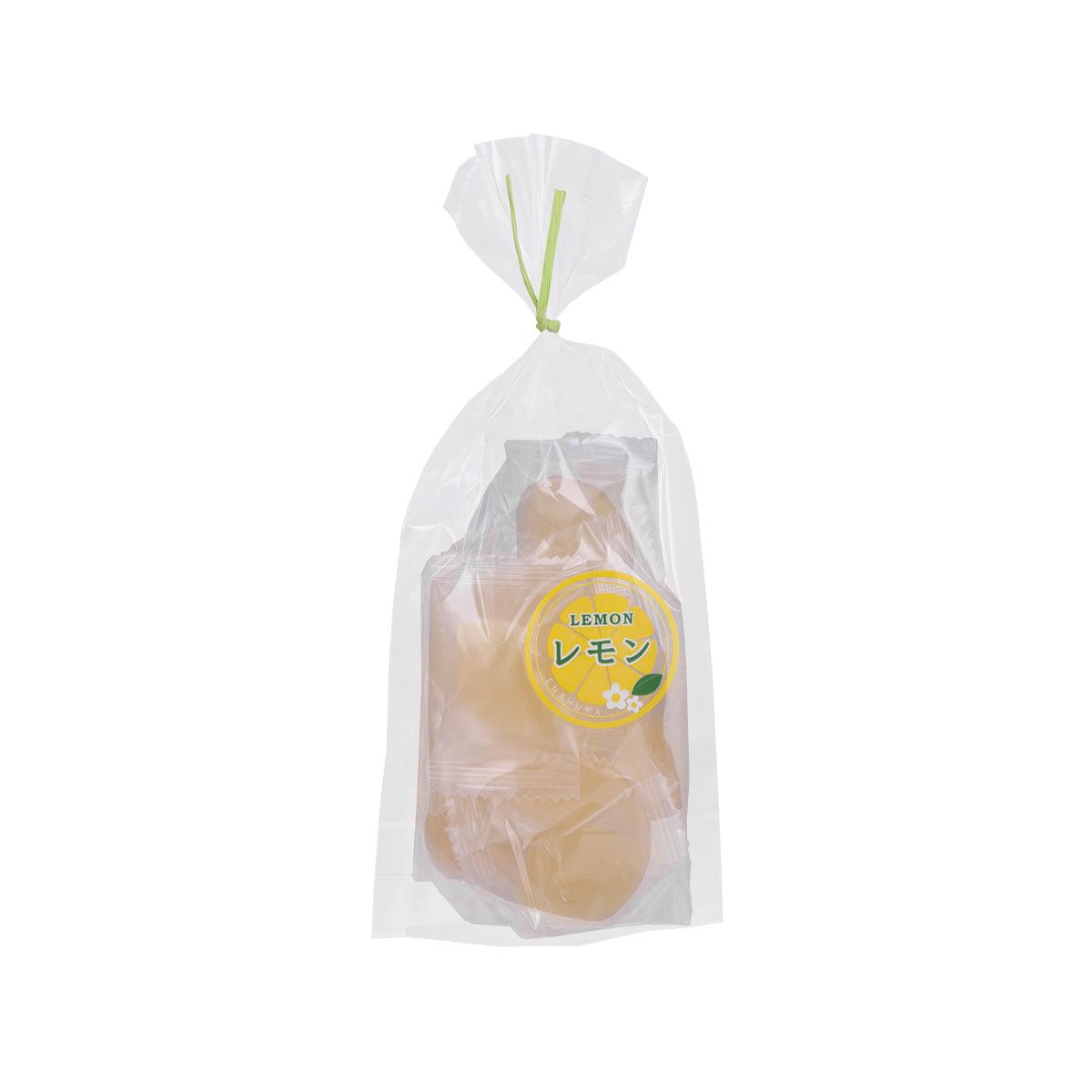Lemon gummy candy in clear bag with yellow round pieces and circular label