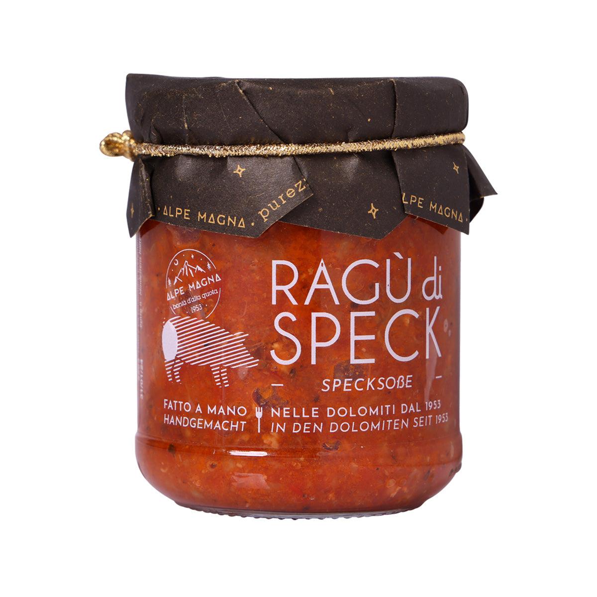 Glass jar of speck sauce with dark brown lid and red label, sealed.