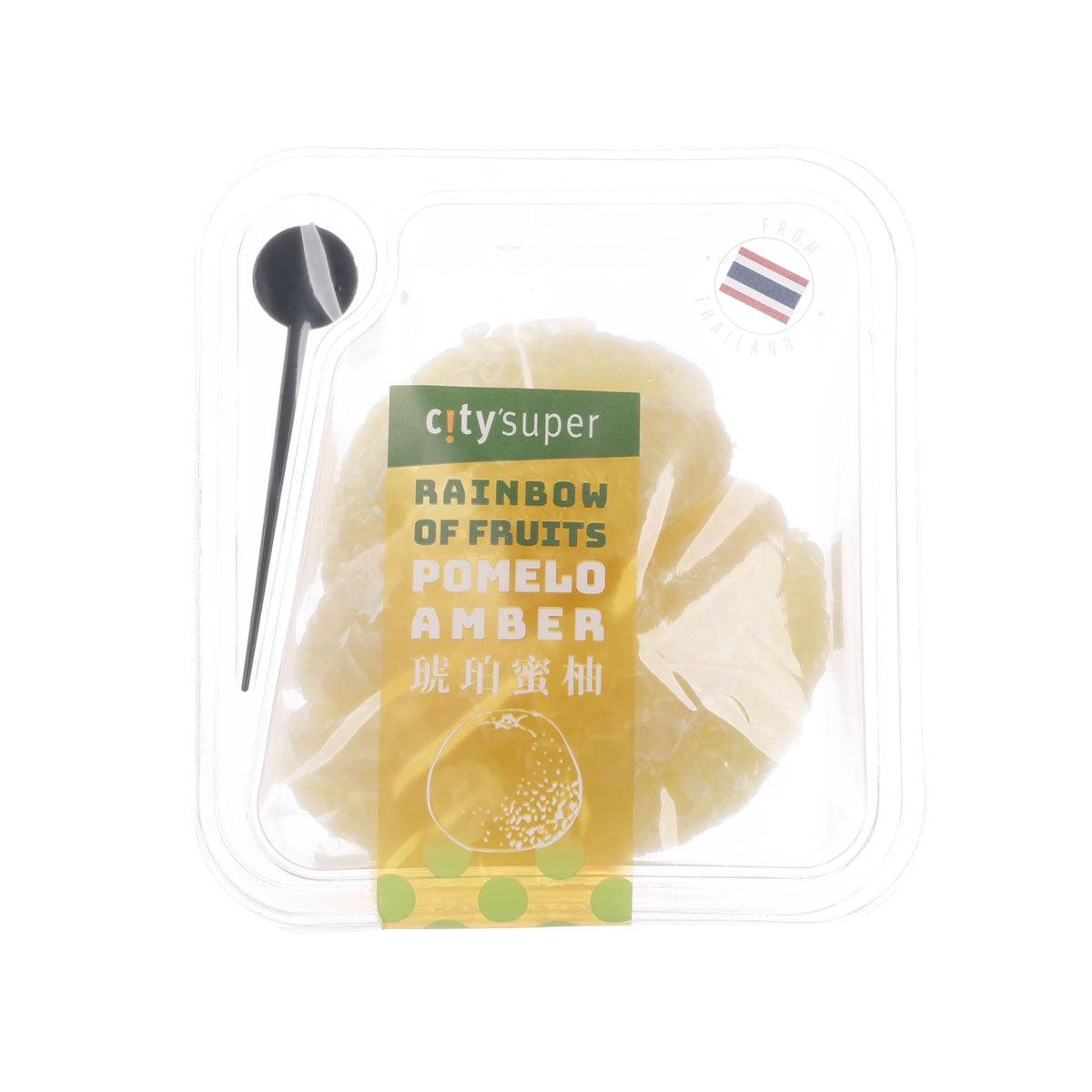 Pomelo amber scented wax candle in clear plastic clamshell with wooden spoon.