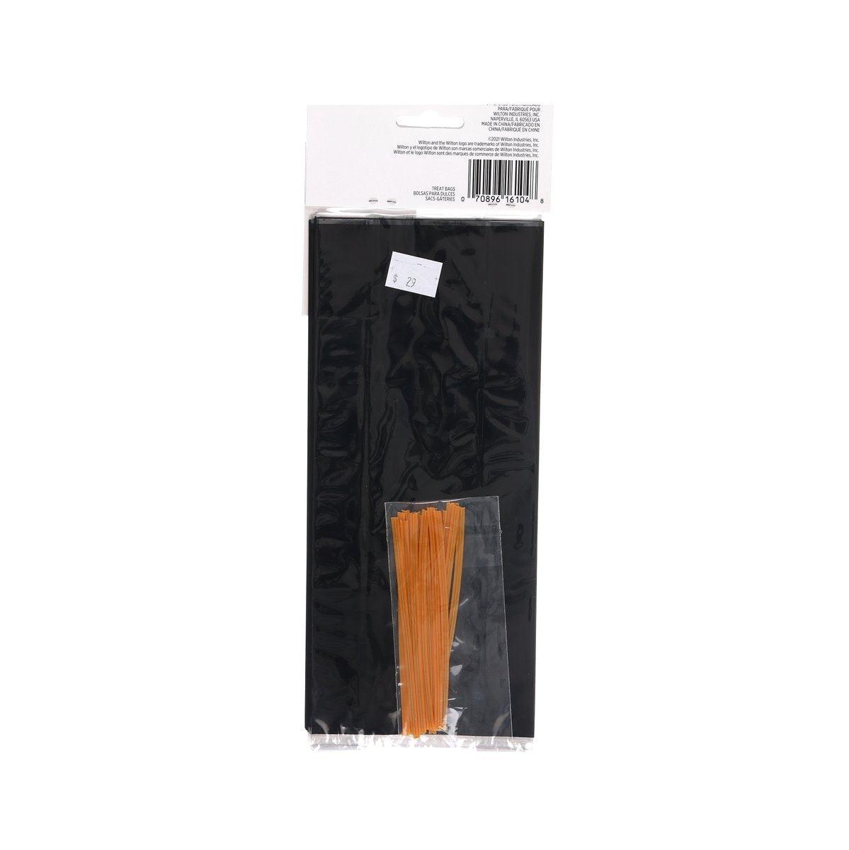 Black Halloween treat bag with hanging hole and orange pull tabs inside packaging