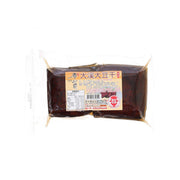Dried tofu blocks, vacuum-sealed in brown package with label on the front