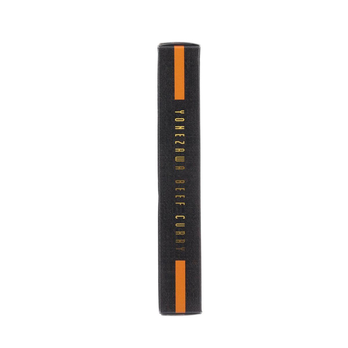 Beef curry carton side view, black with orange stripe and vertical Yonezawa text