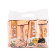 Packaged vegan sesame sauce noodles in a clear plastic bag with handle cutout