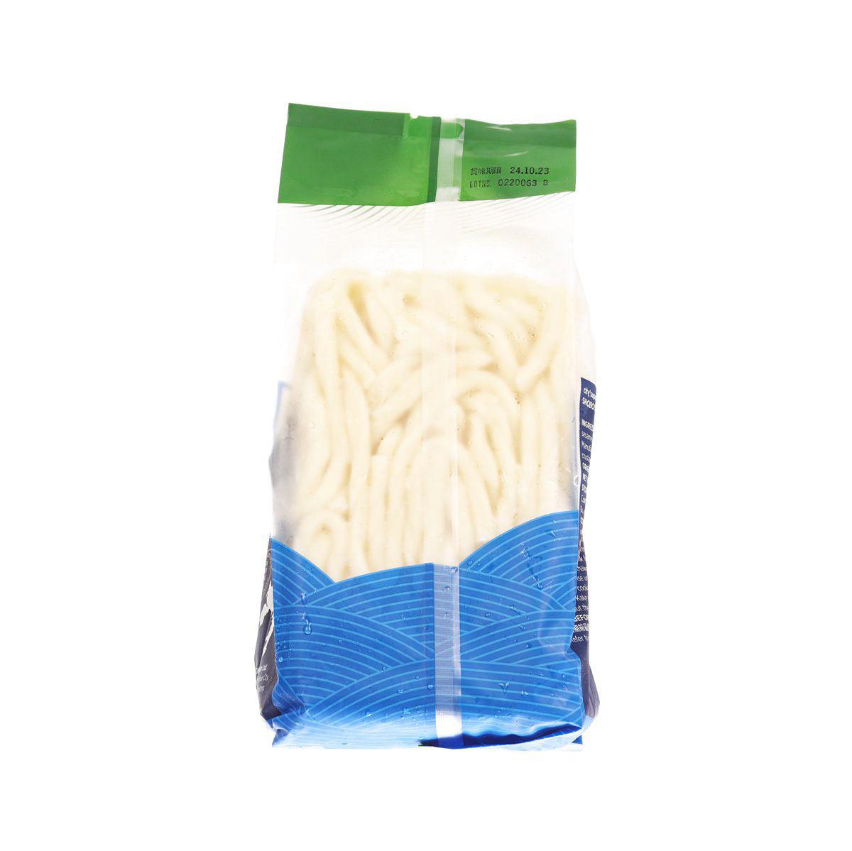 Frozen udon noodles in clear bag, pale strands visible; green seal and blue bottom