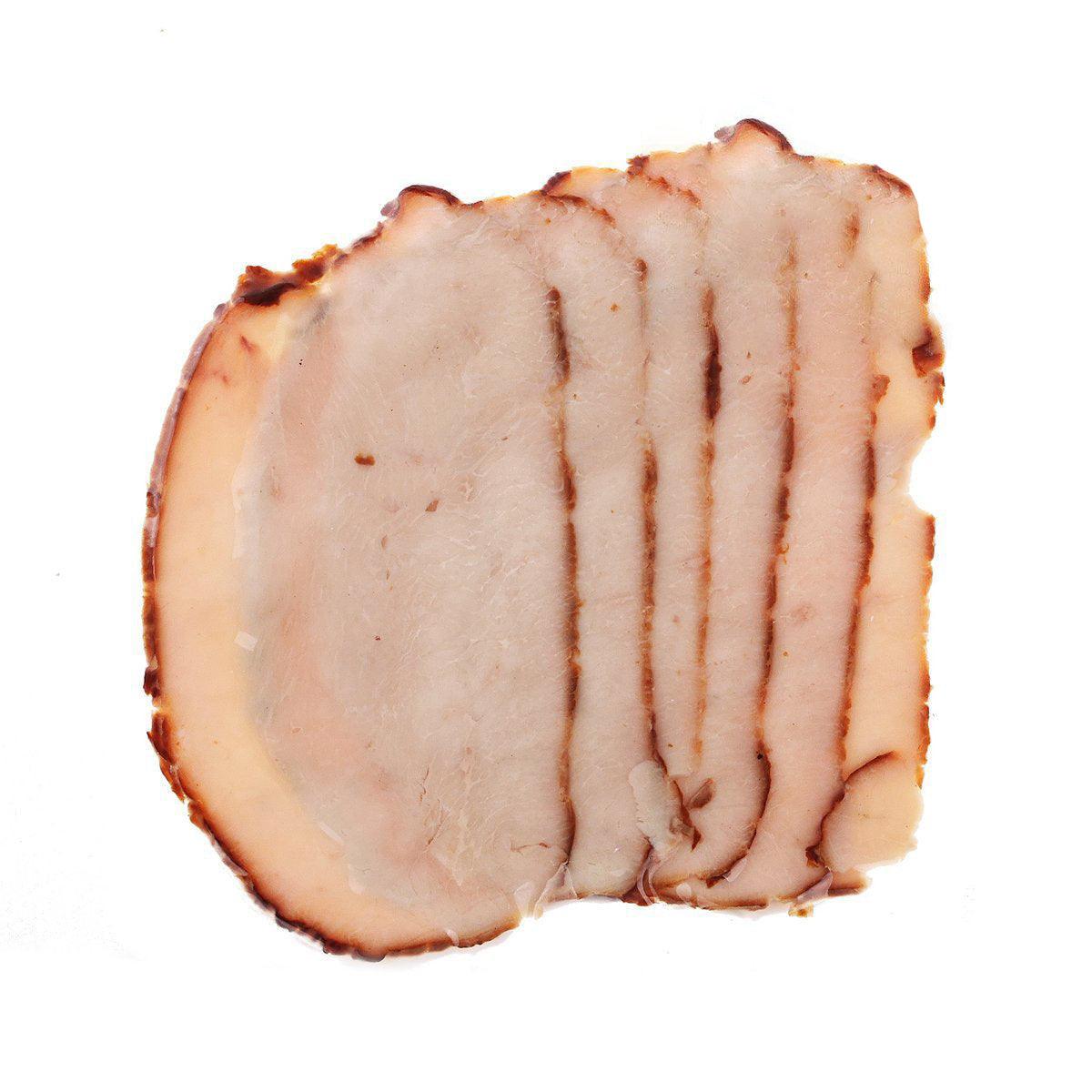 Naturally smoked turkey breast slice, pale pink with browned smoked edges