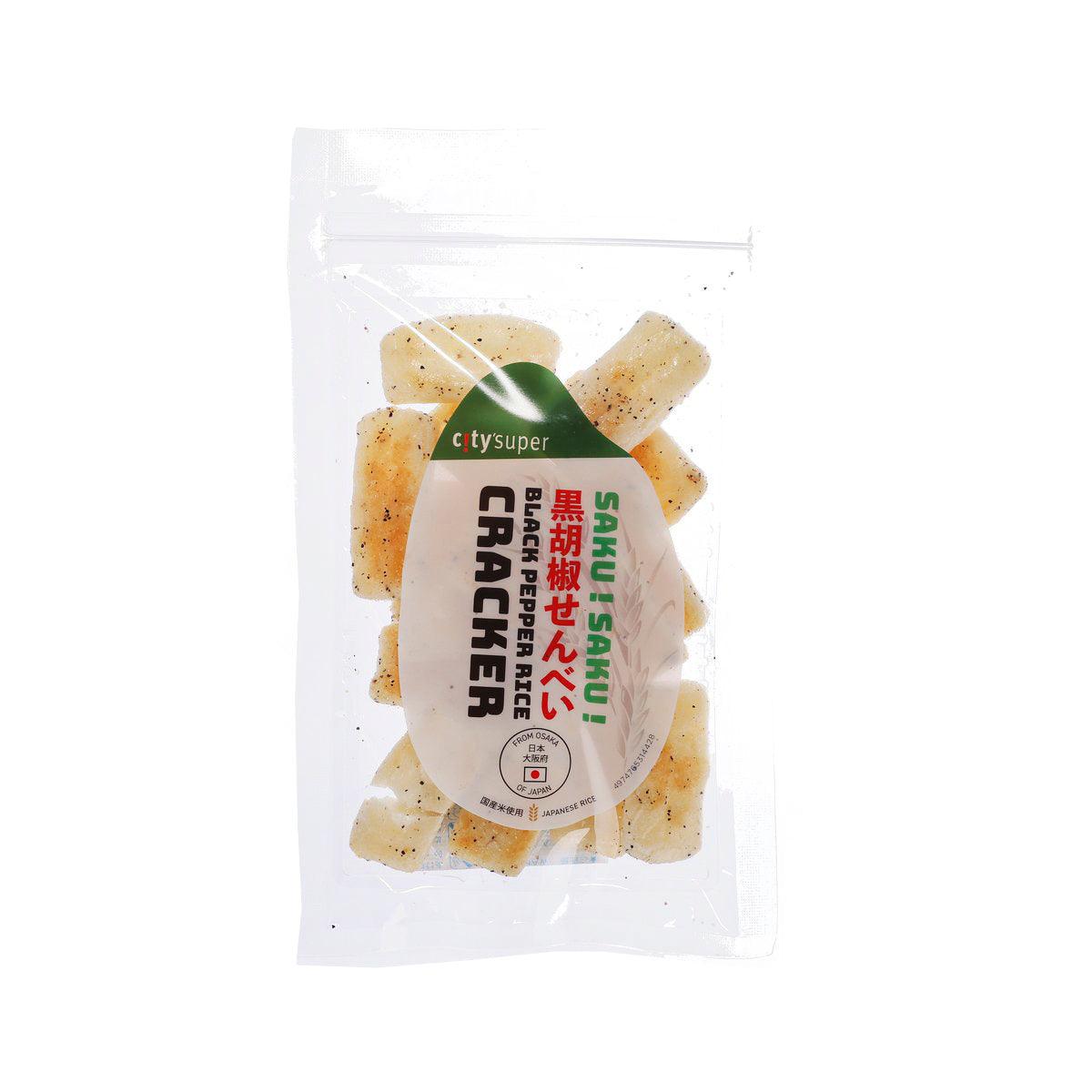 Black pepper rice cracker pouch with scattered cracker pieces and front label