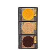 Shrimp cracker assortment tray with three round crackers in orange, tan, and dark brown
