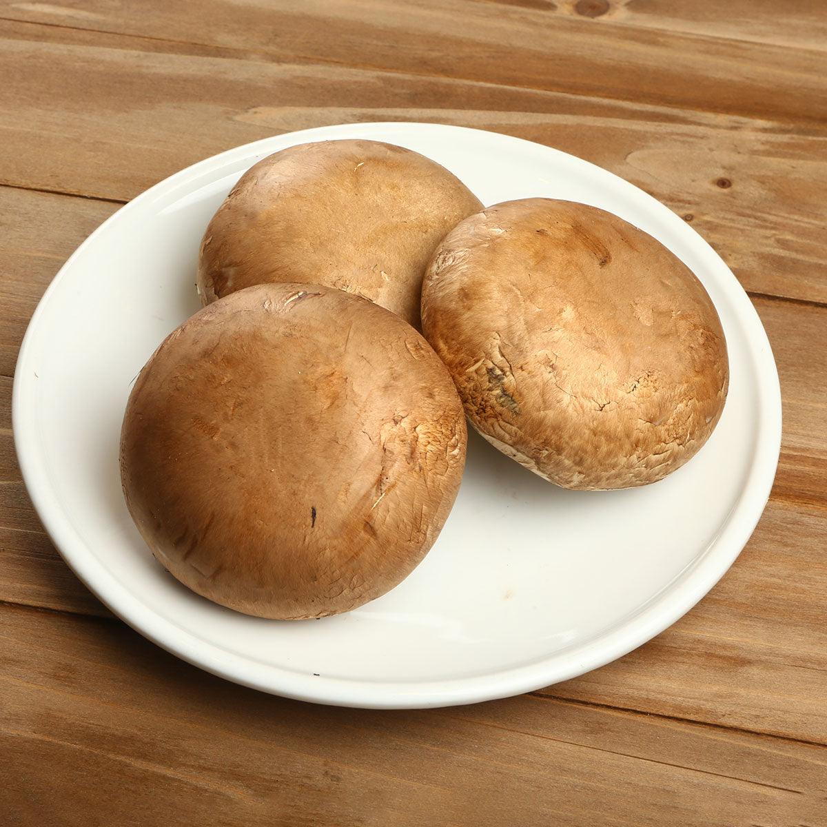 Organic jumbo portobello mushrooms on a white plate