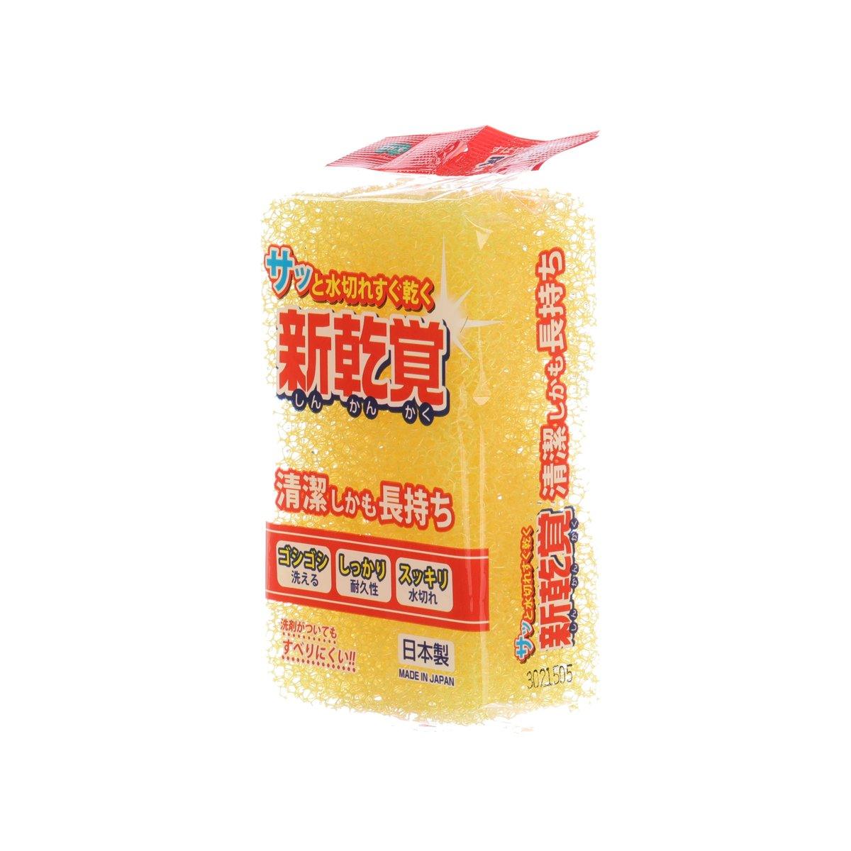 Yellow kitchen sponge in wrapper, side label and Japanese text visible
