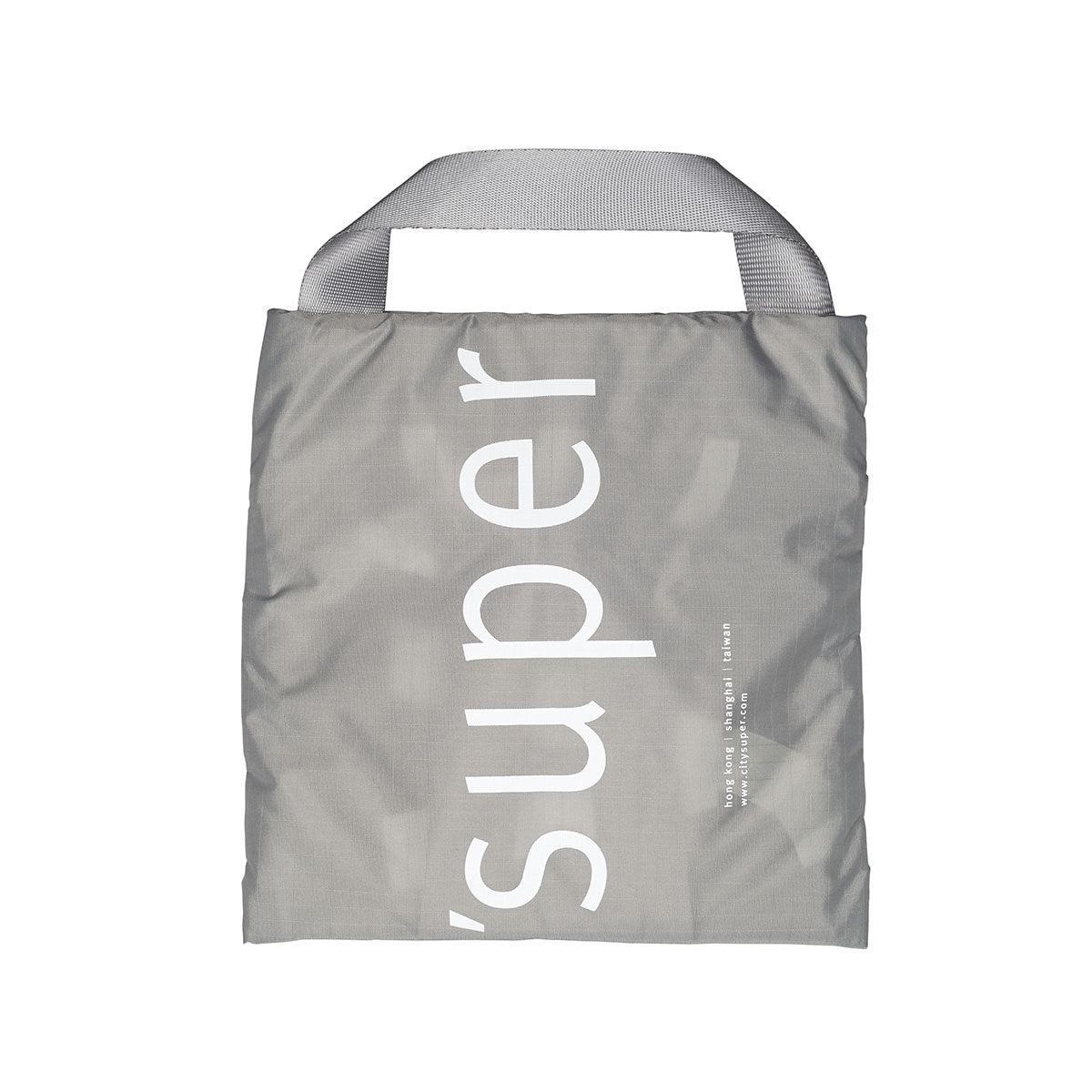 Taupe foldable tote with long handles and vertical white logo print on back