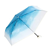 Mini blue gradient umbrella with clear panels and curved white handle