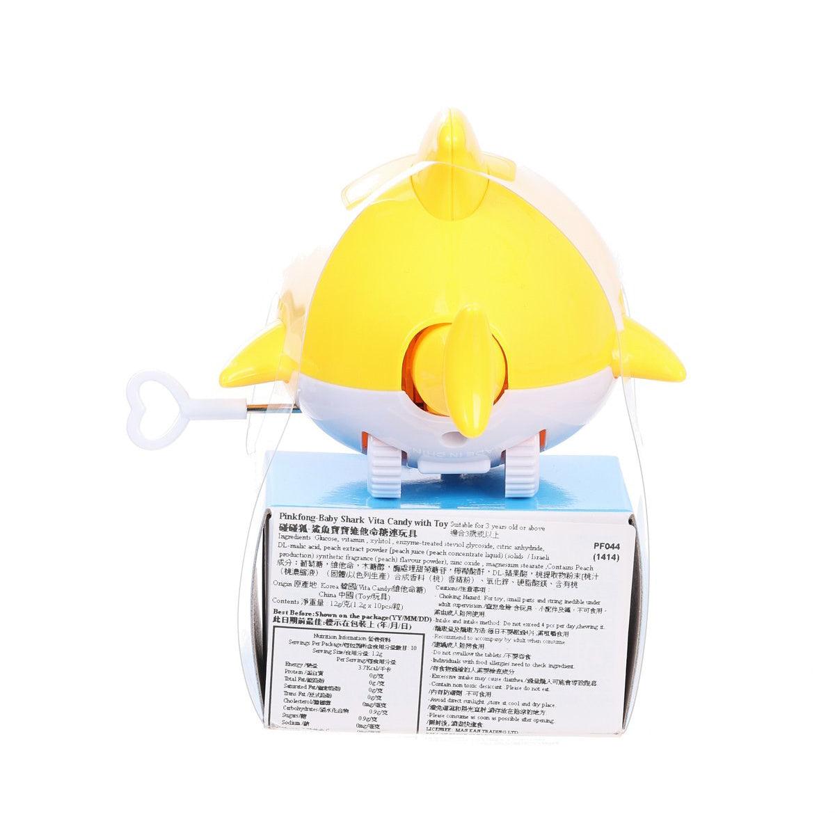 Yellow shark toy on top of candy box, showing back label with ingredient text