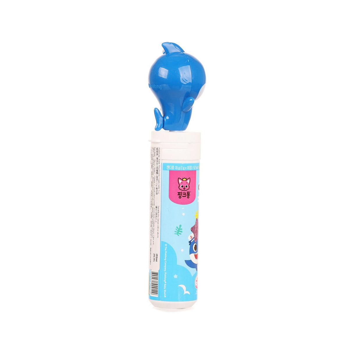 Peach candy tube with blue shark toy topper, blue animal-themed label