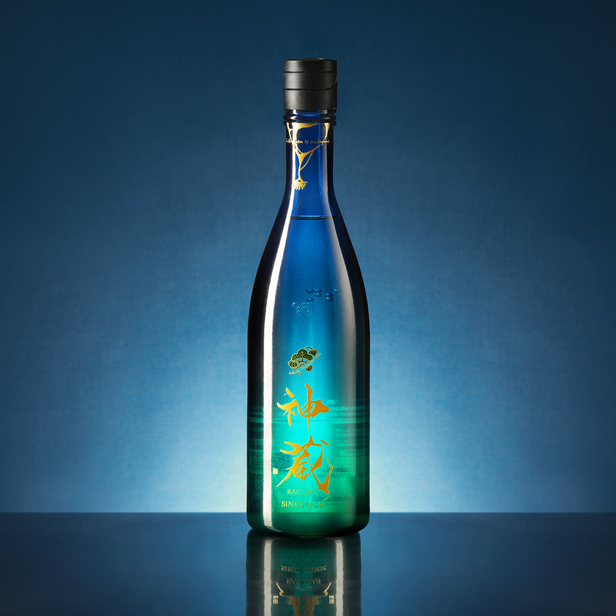 Blue sake bottle standing upright with black cap and gold script label