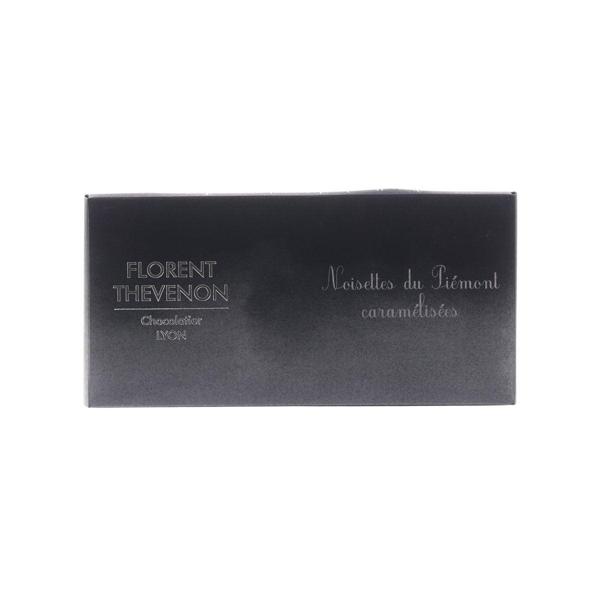 Dark chocolate bar box with FLORENT THEVENON logo and caramelized Piemonte hazelnuts text