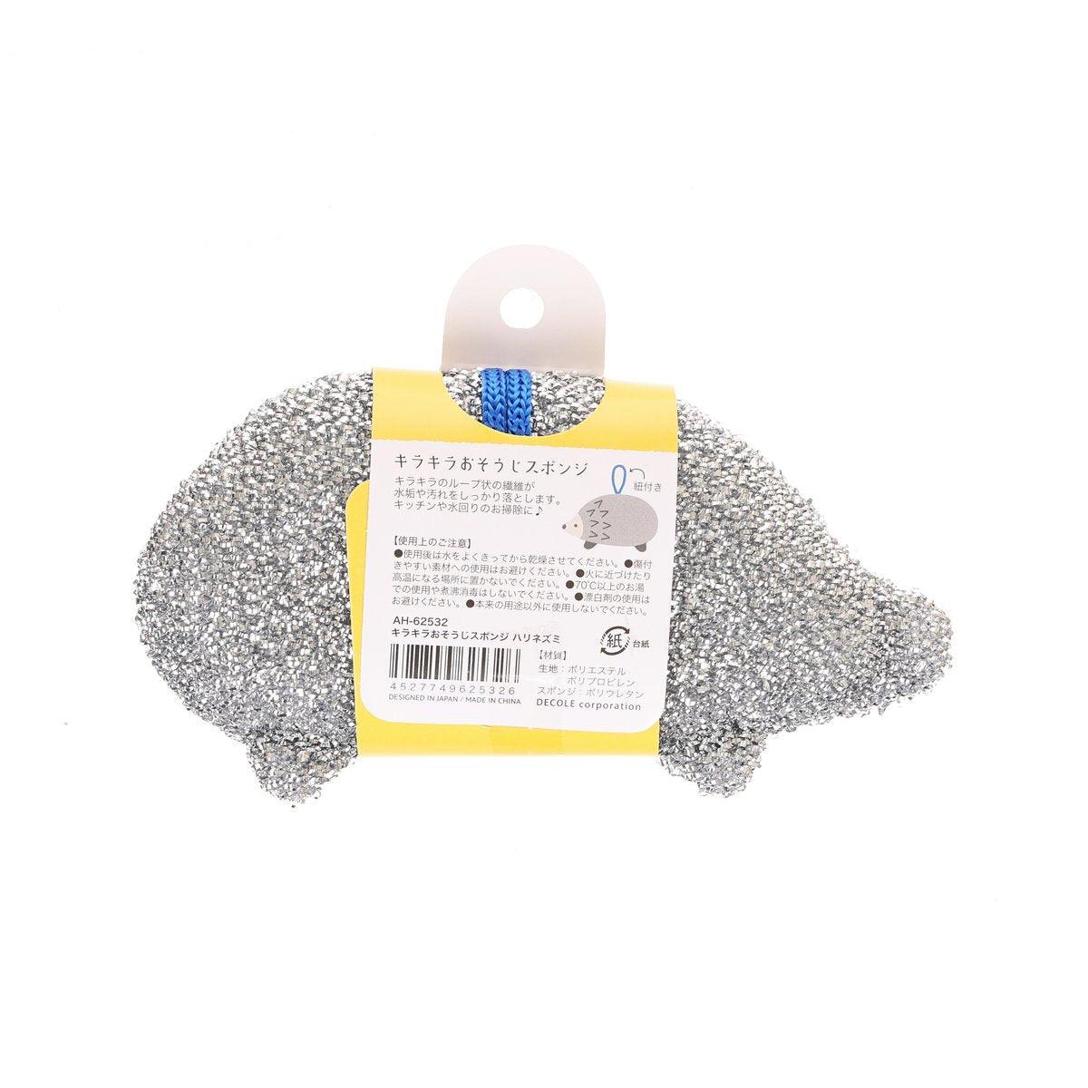 Hedgehog-shaped cleaning sponge, grey scrubbing surface with yellow hang tag loop