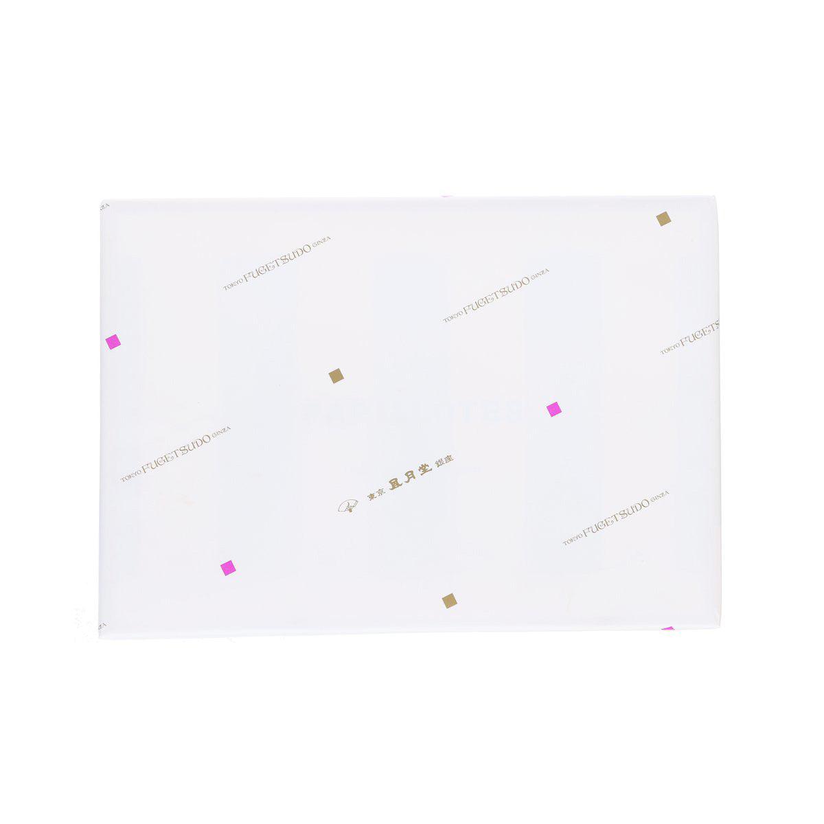 White rectangular box with gold and pink geometric accents