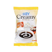KEYCOFFEE Creamy coffee creamer sachet, yellow and clear front pouch with coffee swirl icon