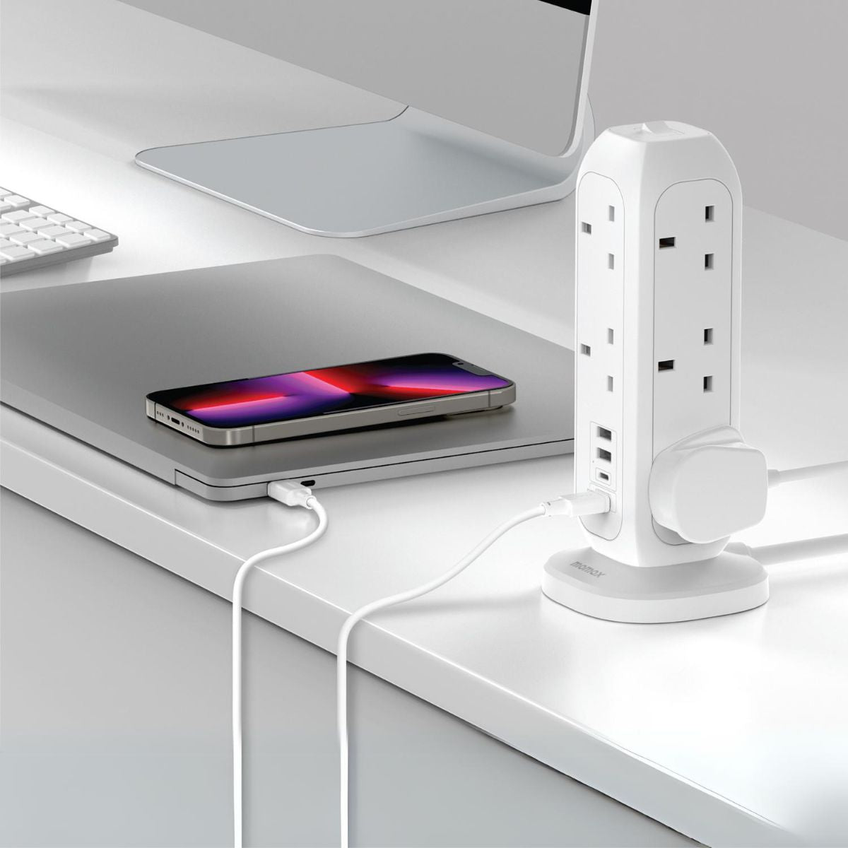 White 11-outlet power strip with USB ports, standing on a desk