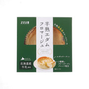 Edam cheese cake gateau in green retail box with sliced cake photo