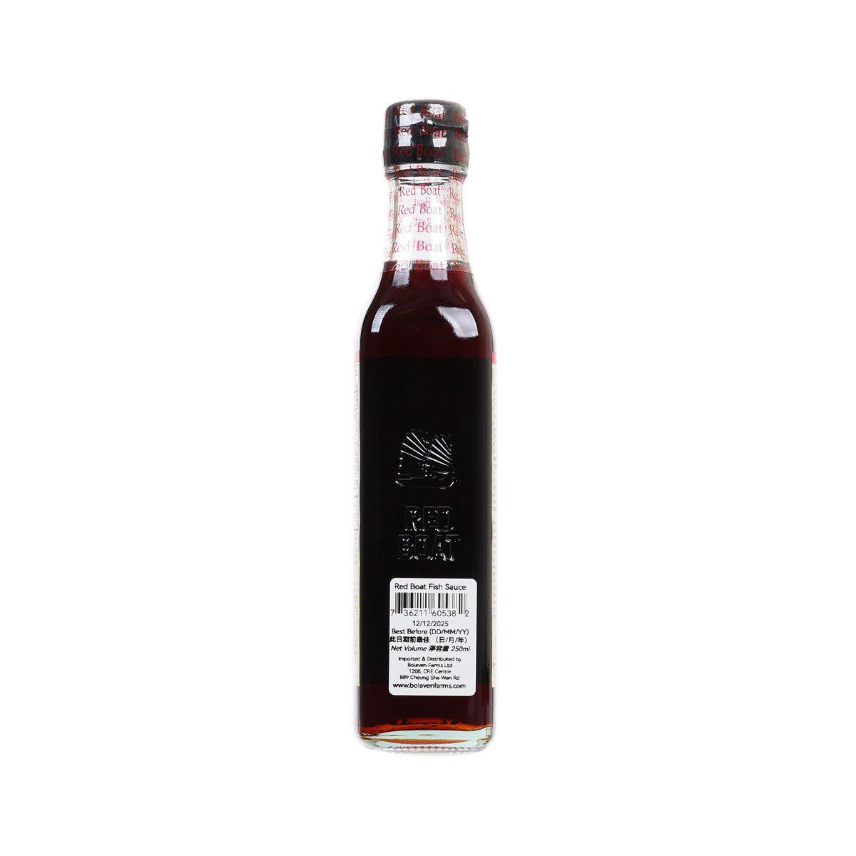 Fish sauce bottle with dark side label, barcode and product information