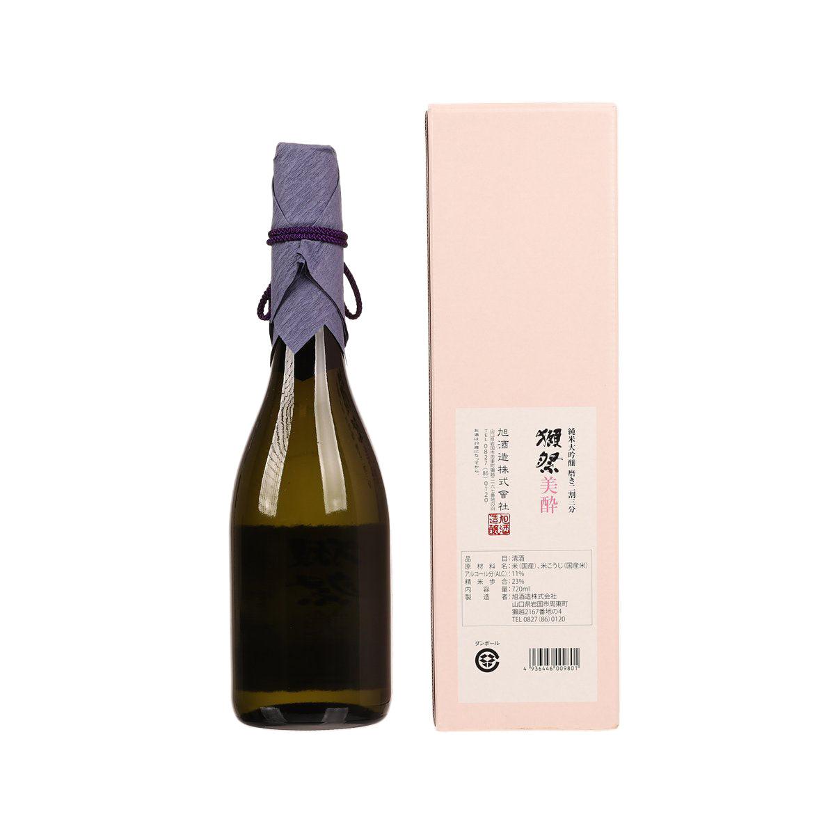 Green glass sake bottle with purple tied neck, shown beside pink rectangular box