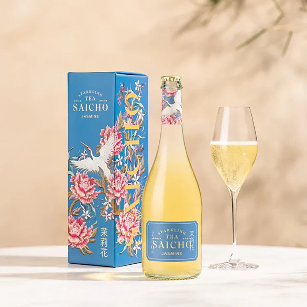 Jasmine sparkling tea bottle with matching box and filled wine glass