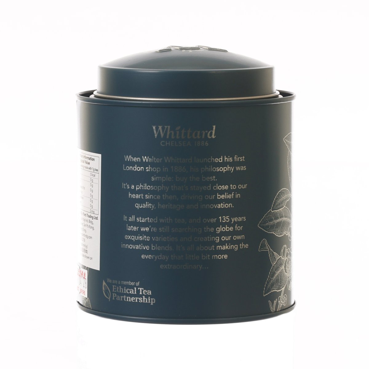 Dark blue Whittard loose tea tin with printed story panel and botanical design